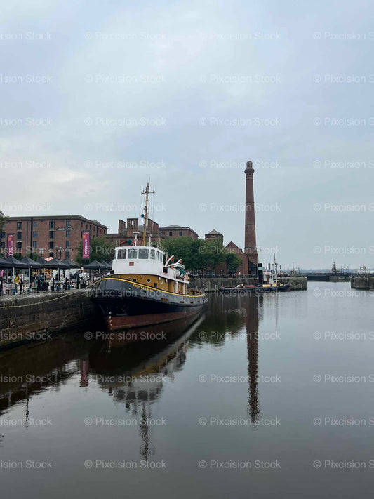 Historic Tugboat Brocklebank Moored at Albert Dock with Victorian Pumphouse Chimney Liverpool England