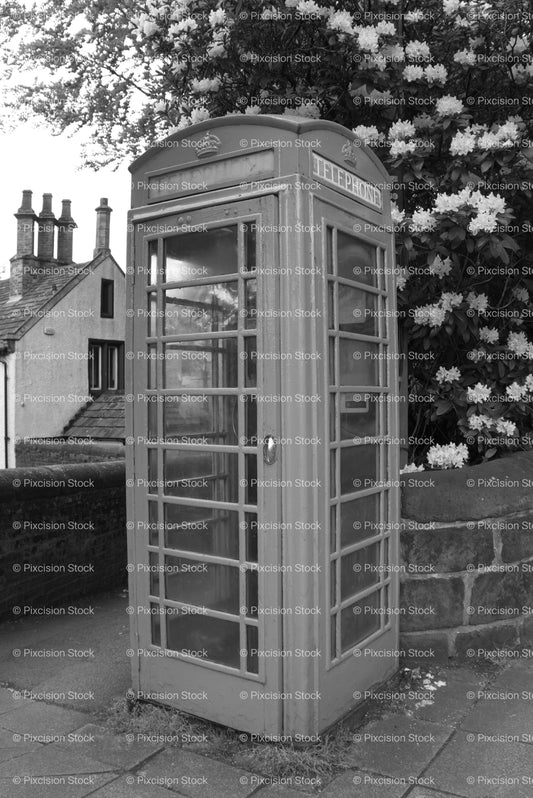 Vintage K6-Style Telephone Box Beside a Stone Wall (Monochrome) - Stock Video