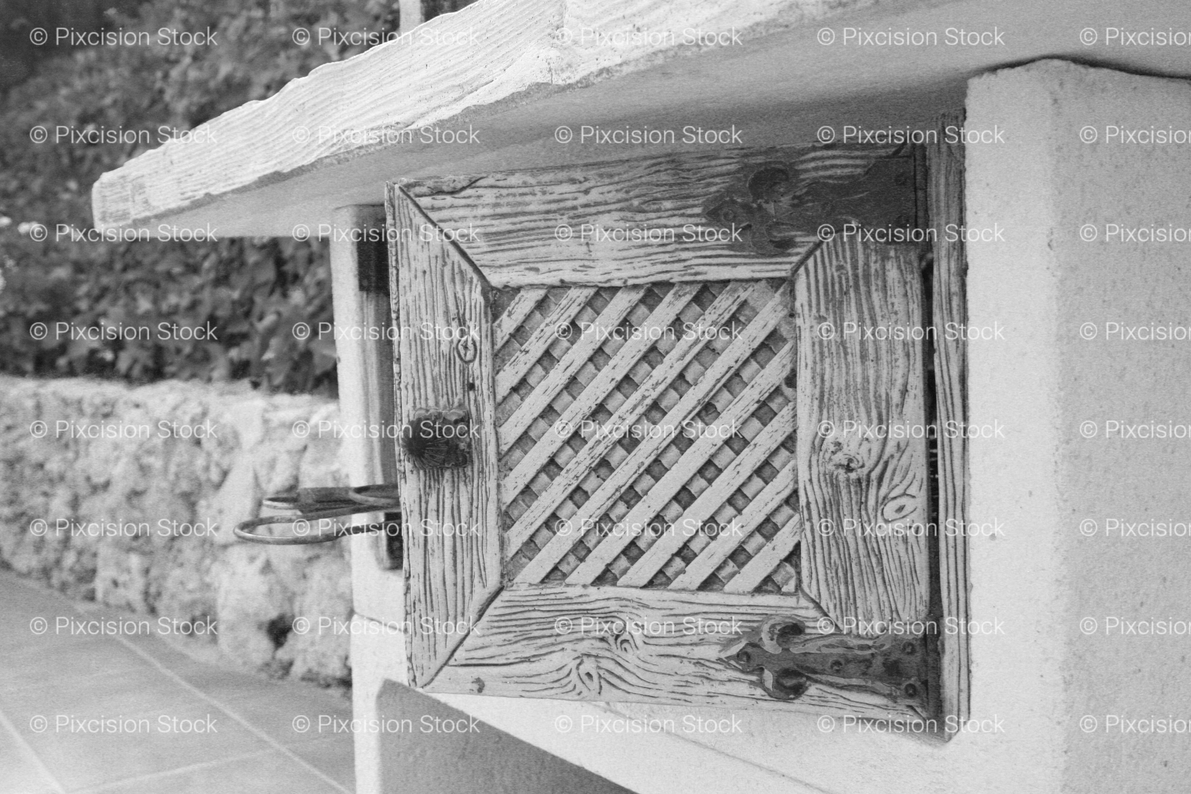 Small Window with Decorative Grille on a Stucco Wall (Monochrome)