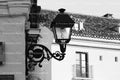 Ornate Wrought Iron Wall Lantern on a Building Exterior (Monochrome)