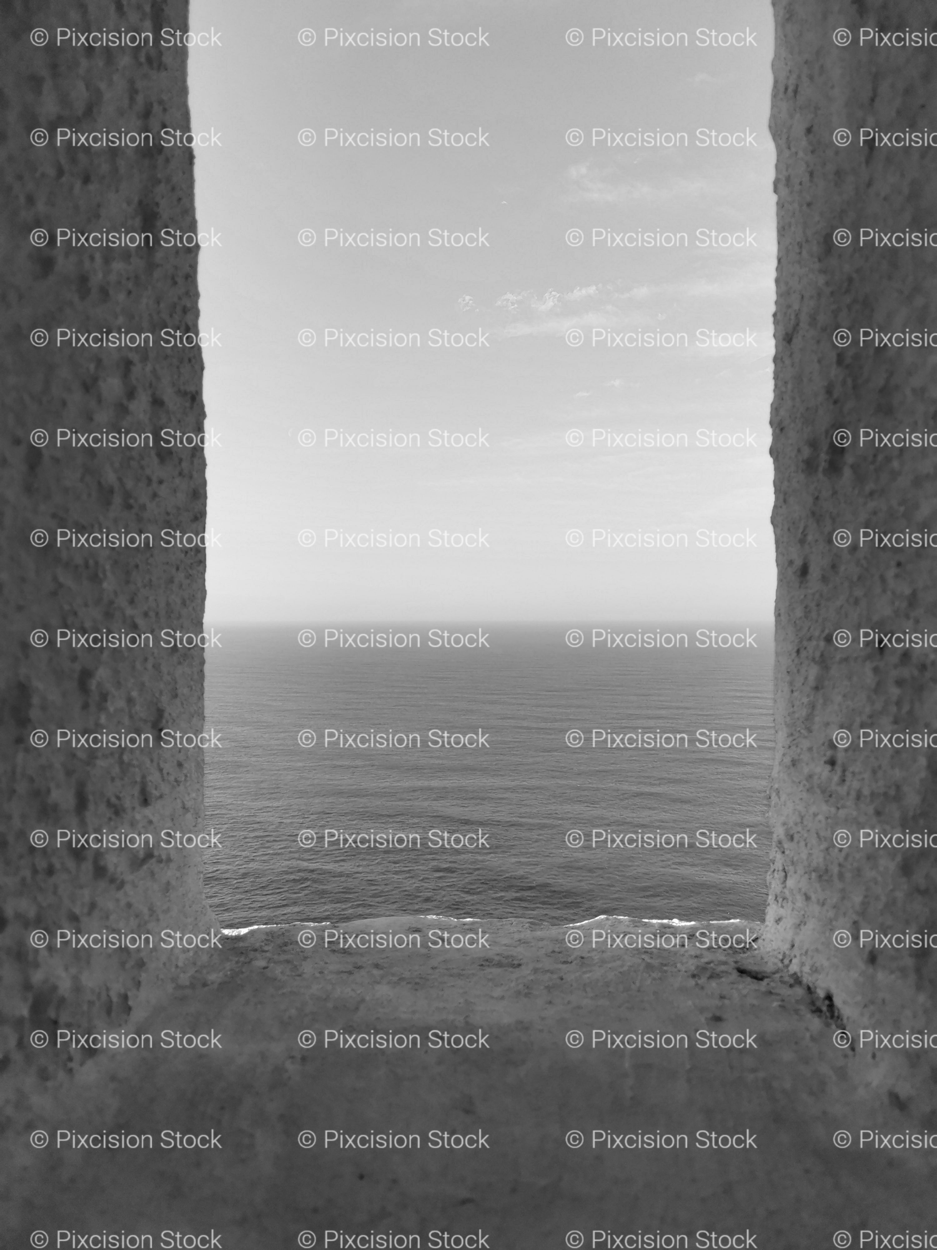 Narrow Vertical View Framed by Stone Pillars looking toward the Horizon (Monochrome)