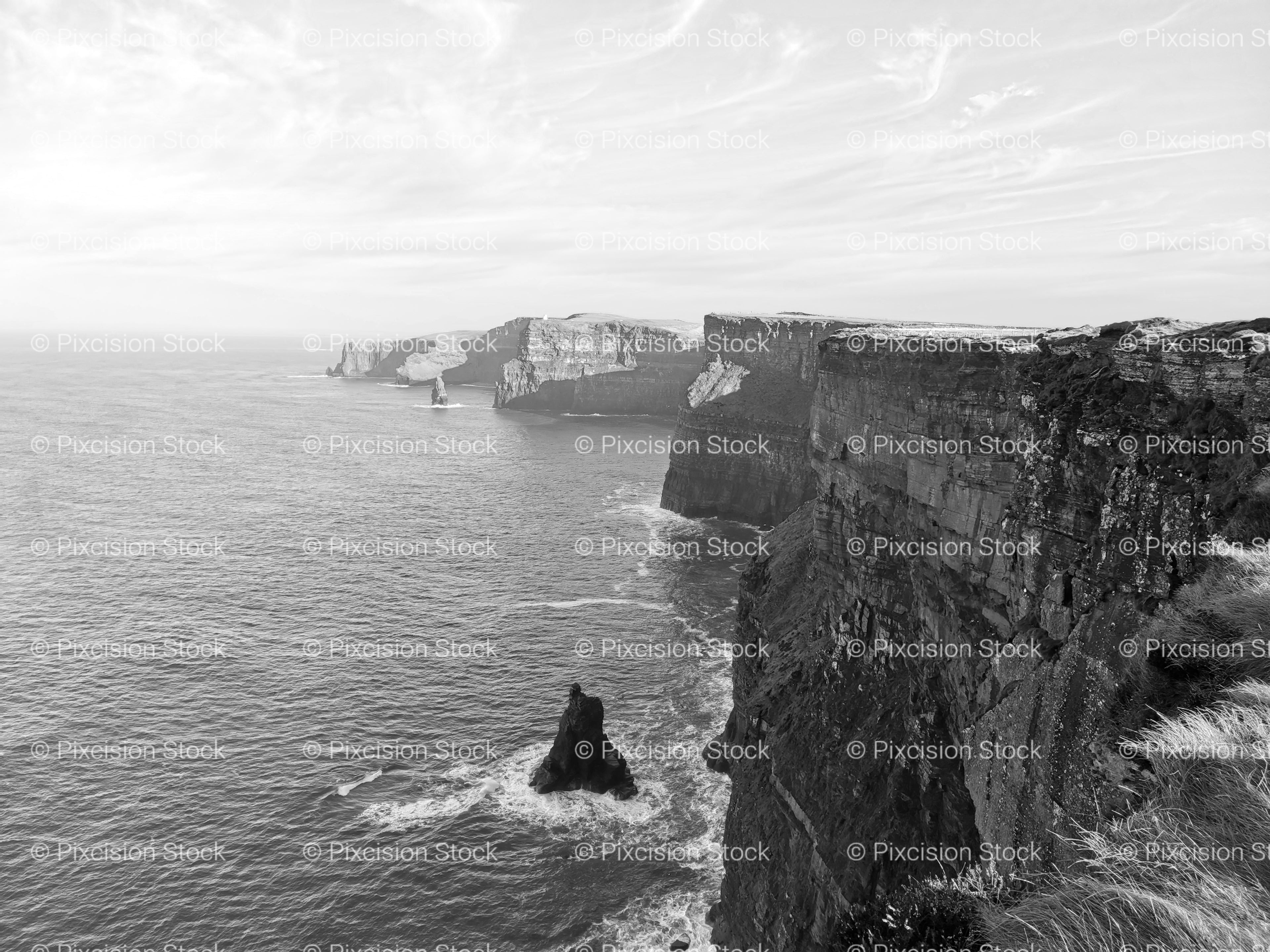 High-Angle View of Crashing Waves Against Rocky Cliffs (Monochrome)
