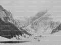 Wide View of a Frozen Alpine Lake Surrounded by Rugged Peaks (Monochrome)