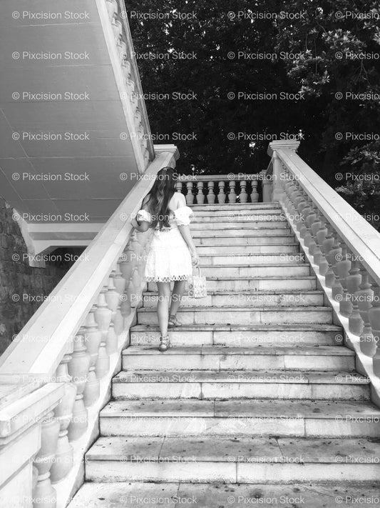Person Walking Up a Long, Symmetrical Outdoor Stone Staircase (Monochrome) - Stock Video