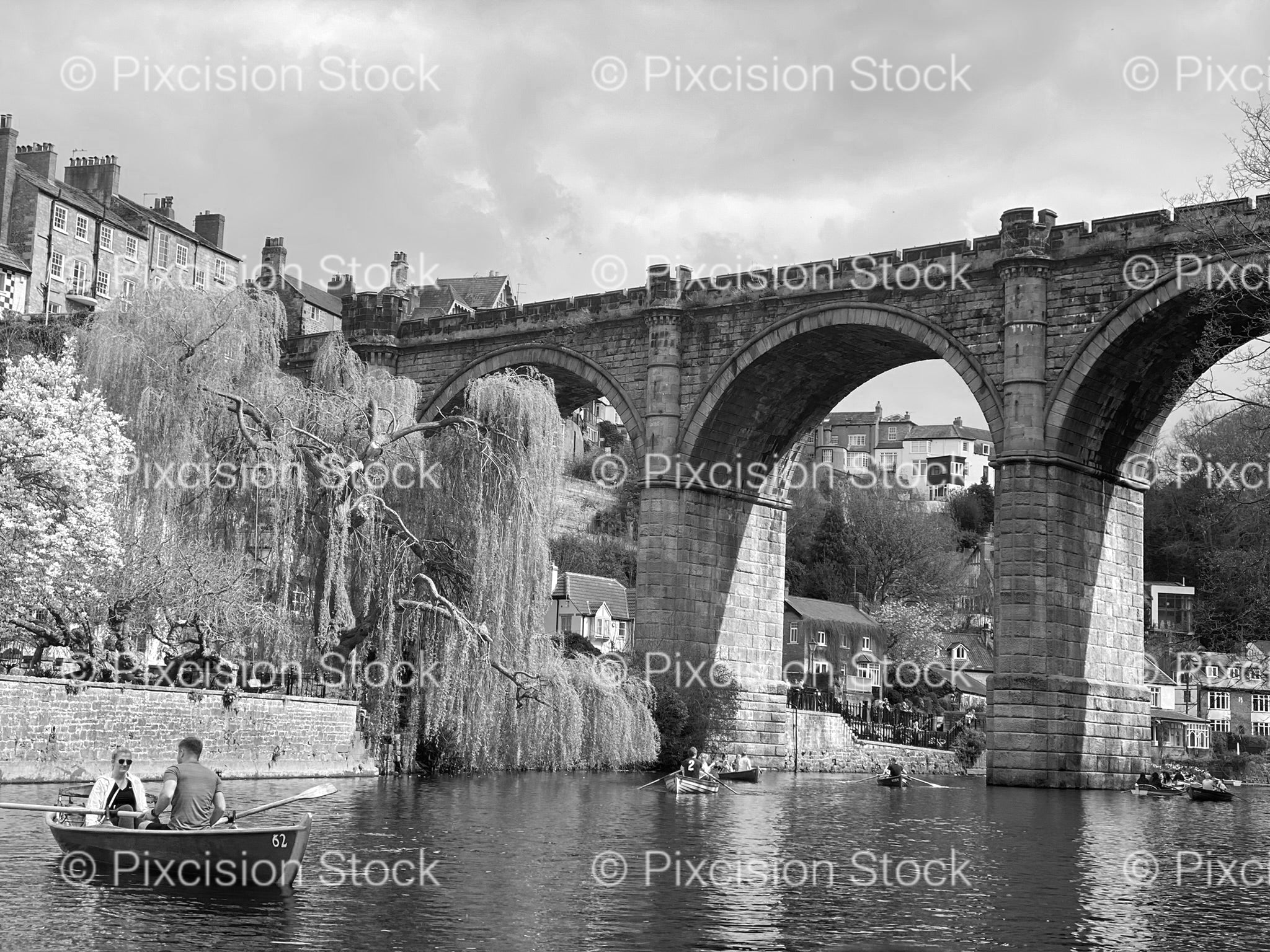 Multi-Arched Stone Bridge Over a River in a Historic Town (Monochrome)