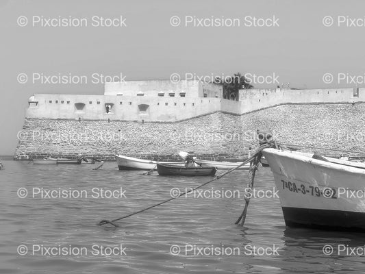 Small Boats Moored Near a Coastal Fortification Wall (Monochrome) - Stock Video