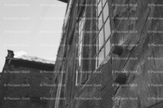 Low-Angle Shot of a Old Wooden Building Corner Against the Sky (Monochrome) - Stock Video