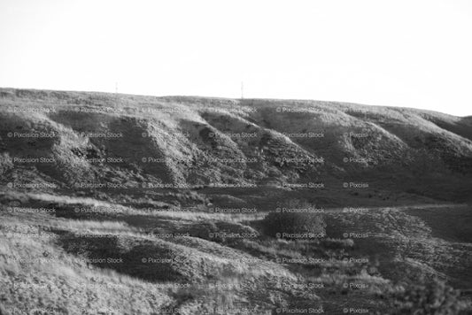 Rugged and Grassy Rolling Hillsides Under a Soft Sky (Monochrome) - Stock Video