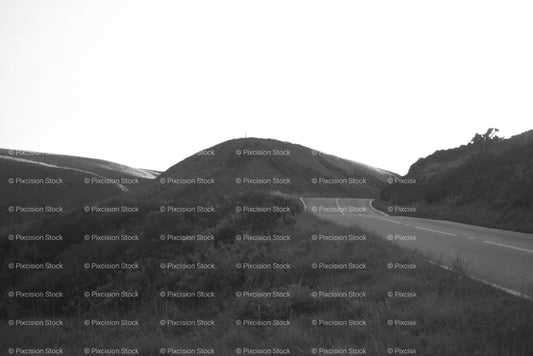 Country Road Curving Through Low, Open Hills (Monochrome) - Stock Video