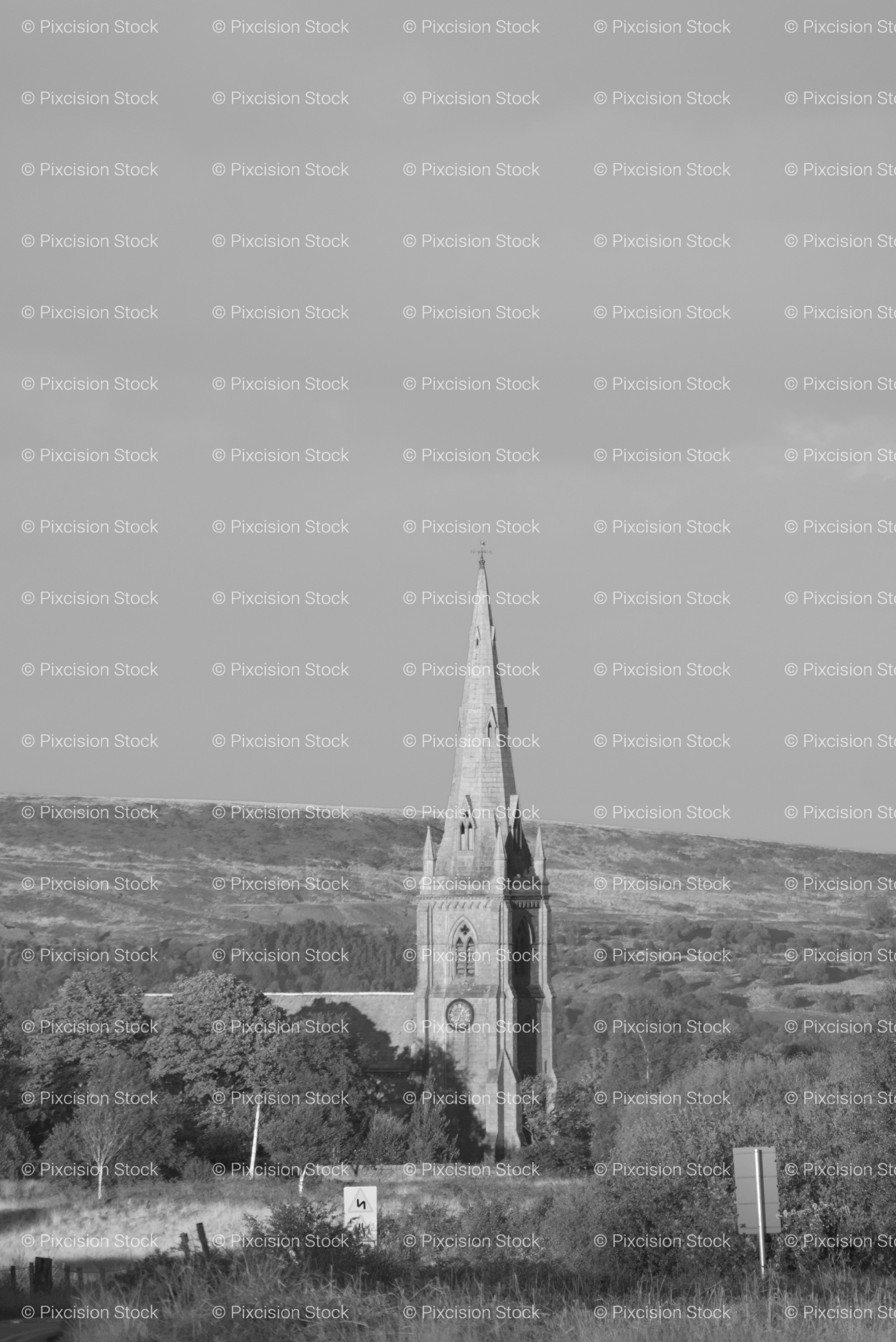 Tall Church Spire Rising Above a Mountainous Valley (Monochrome)