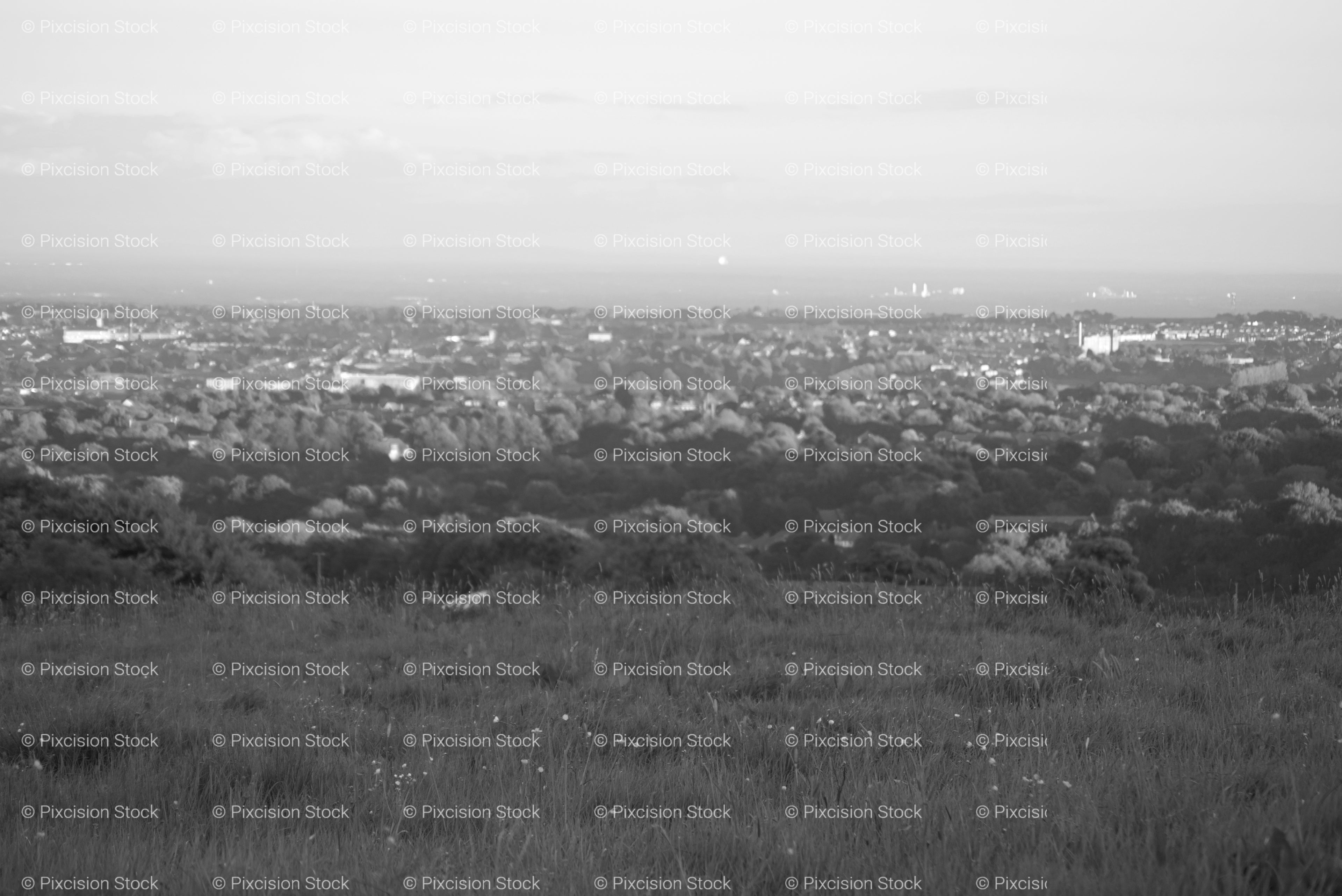 High-Angle Panoramic View Over a Vast Valley and Town Below (Monochrome)