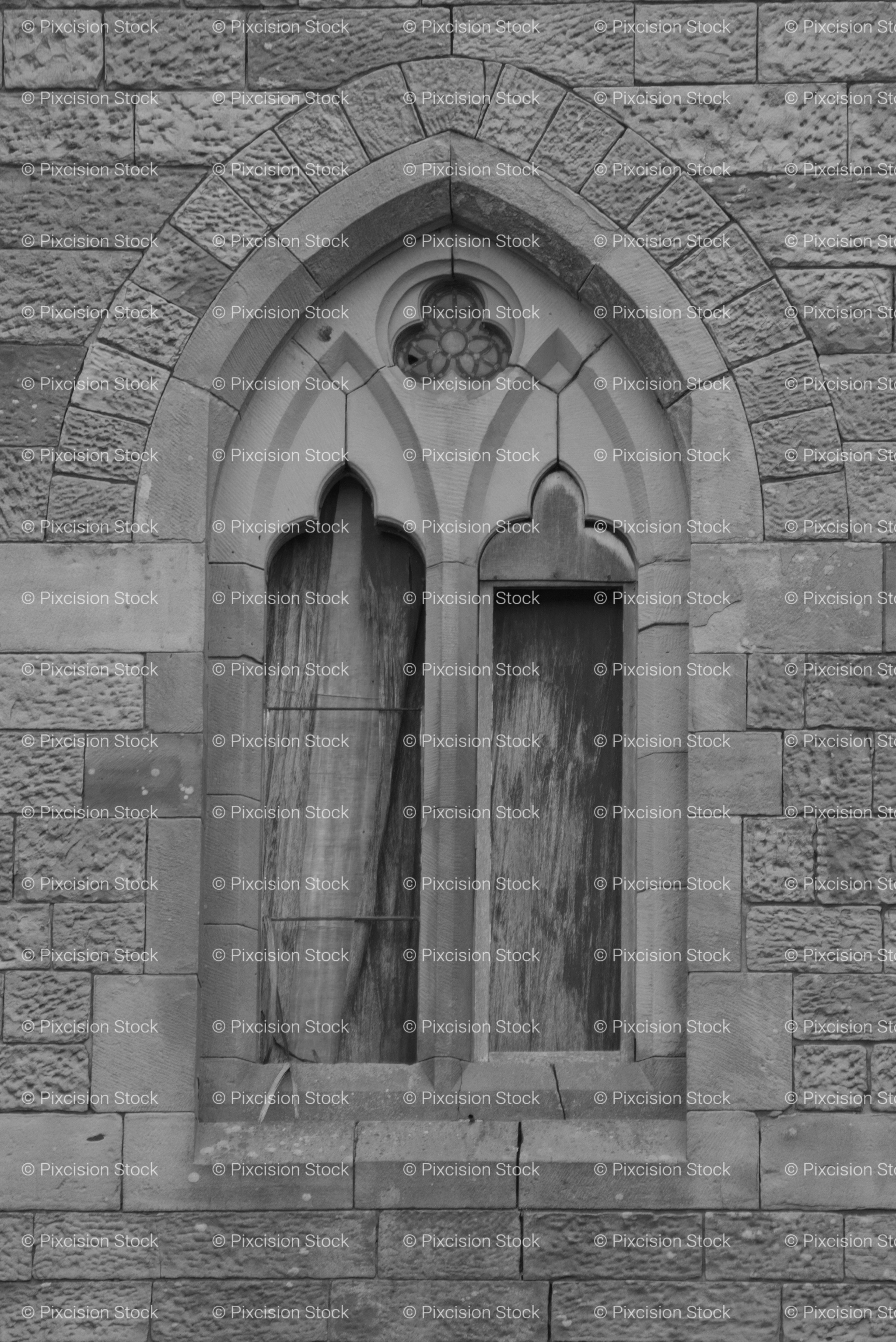 Detail View of a Gothic Arched Window Embedded in a Stone Building (Monochrome)