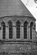 Multi-Windowed Semi-Circular Stone Wall of a Historic Building (Monochrome)