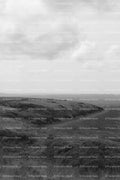 Wide View of a Grassy Valley Under a Cloudy Sky (Monochrome)