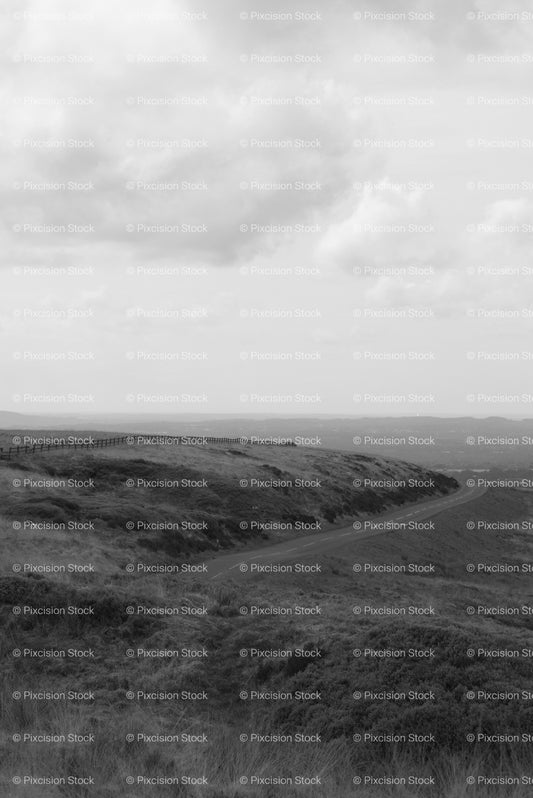 Wide View of a Grassy Valley Under a Cloudy Sky (Monochrome) - Stock Video