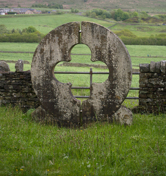 Vertical Shot of a Round Stone Wall Opening in a Pasture