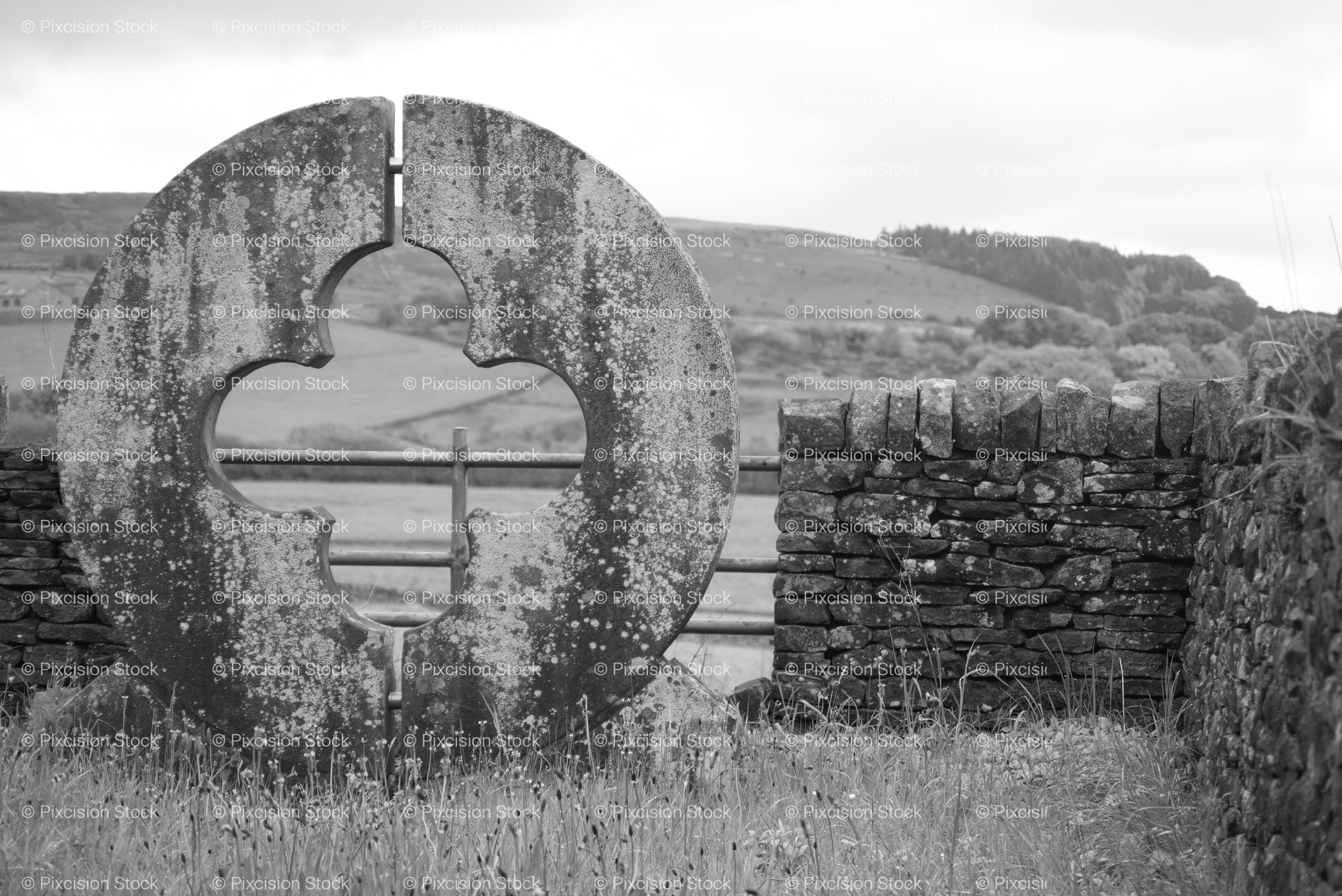 Round Monumental Stone Opening Framing a Countryside View (Monochrome)