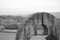 Low-Angle View of a Large Arched or Circular Stone Structure (Monochrome)