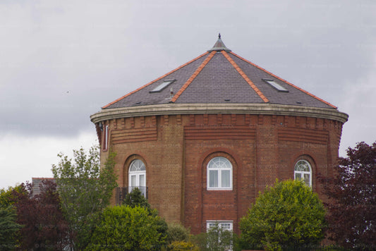 Red brick building with a dome-shaped roof on a cloudy day
