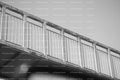 Upward Diagonal View of a Simple Footbridge Railing (Monochrome)