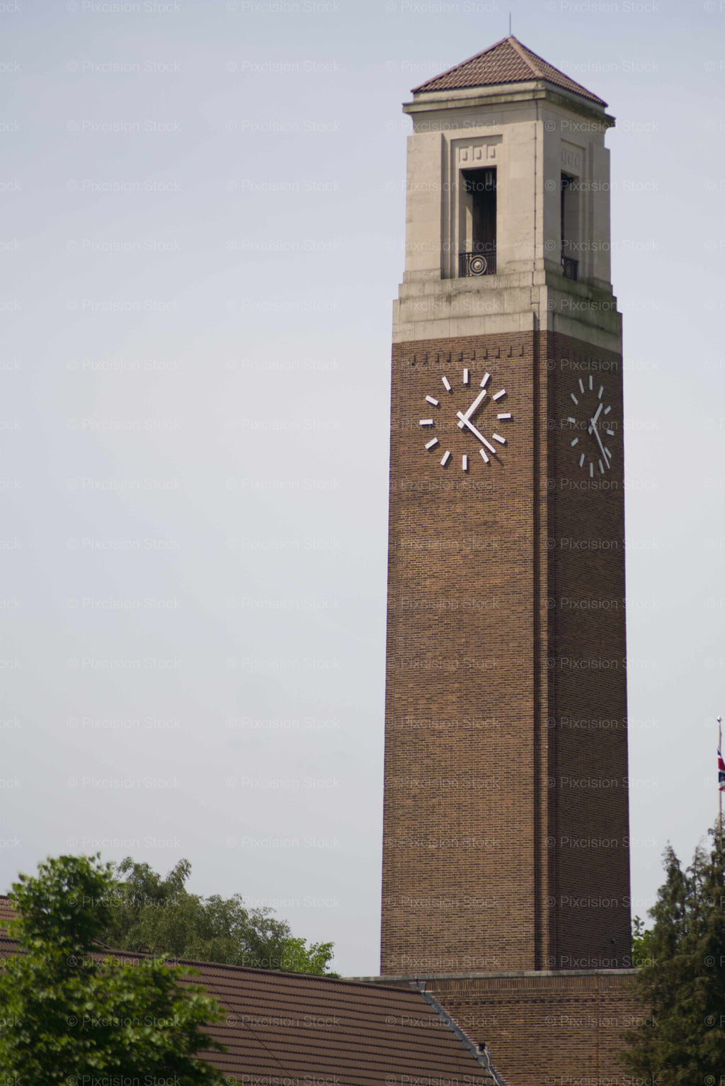 Brick clock tower with a clear sky background