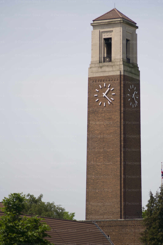 Brick clock tower with a clear sky background
