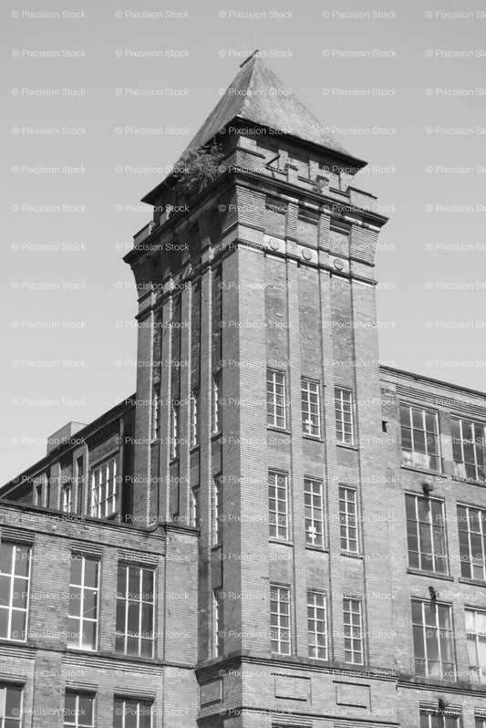 High-Angle View of a Large, Historic Industrial Brick Mill Tower (Monochrome) - Stock Video