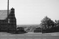 Rural Landscape Featuring a Stone Building and Vast Open Fields (Monochrome)
