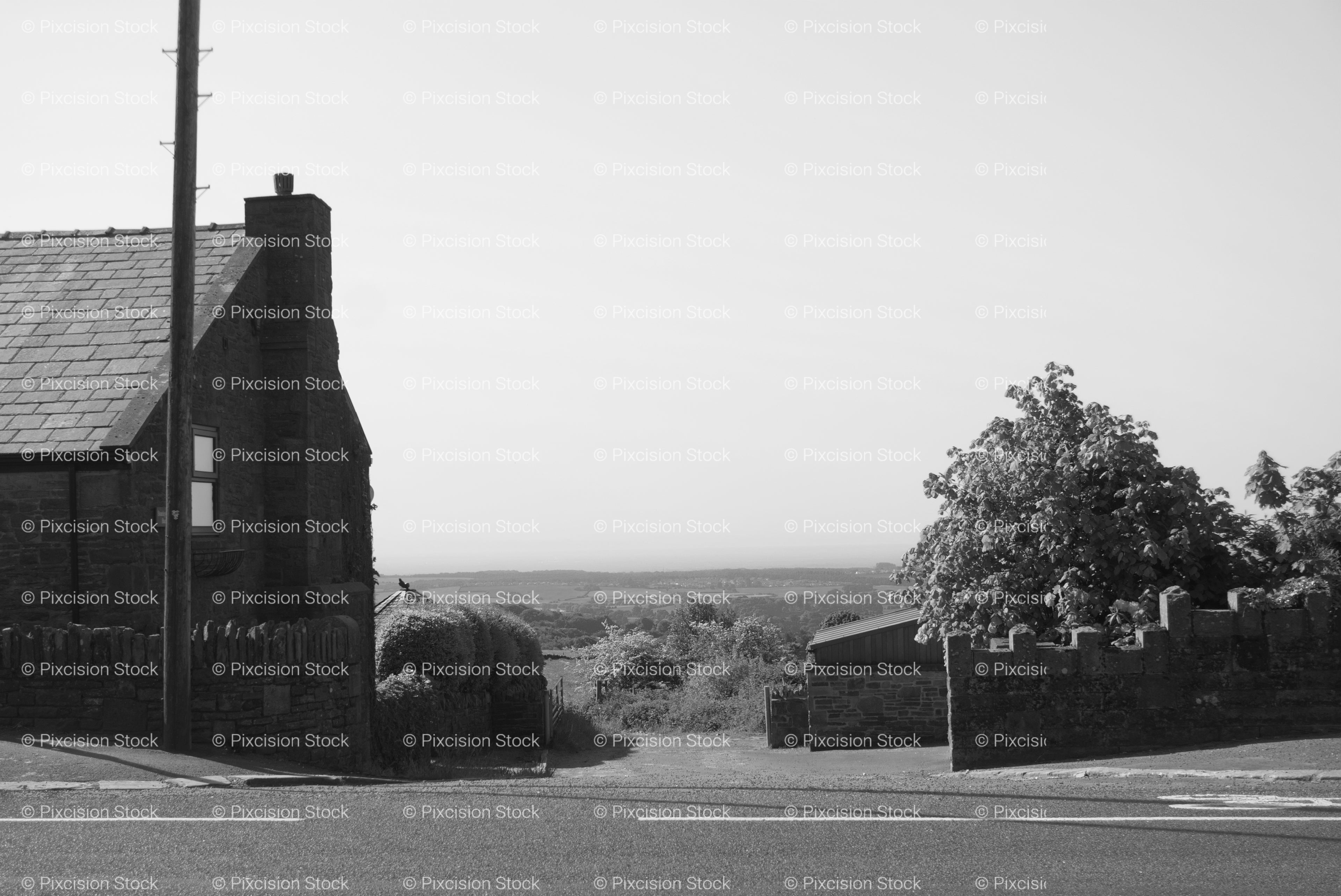 Rural Landscape Featuring a Stone Building and Vast Open Fields (Monochrome)