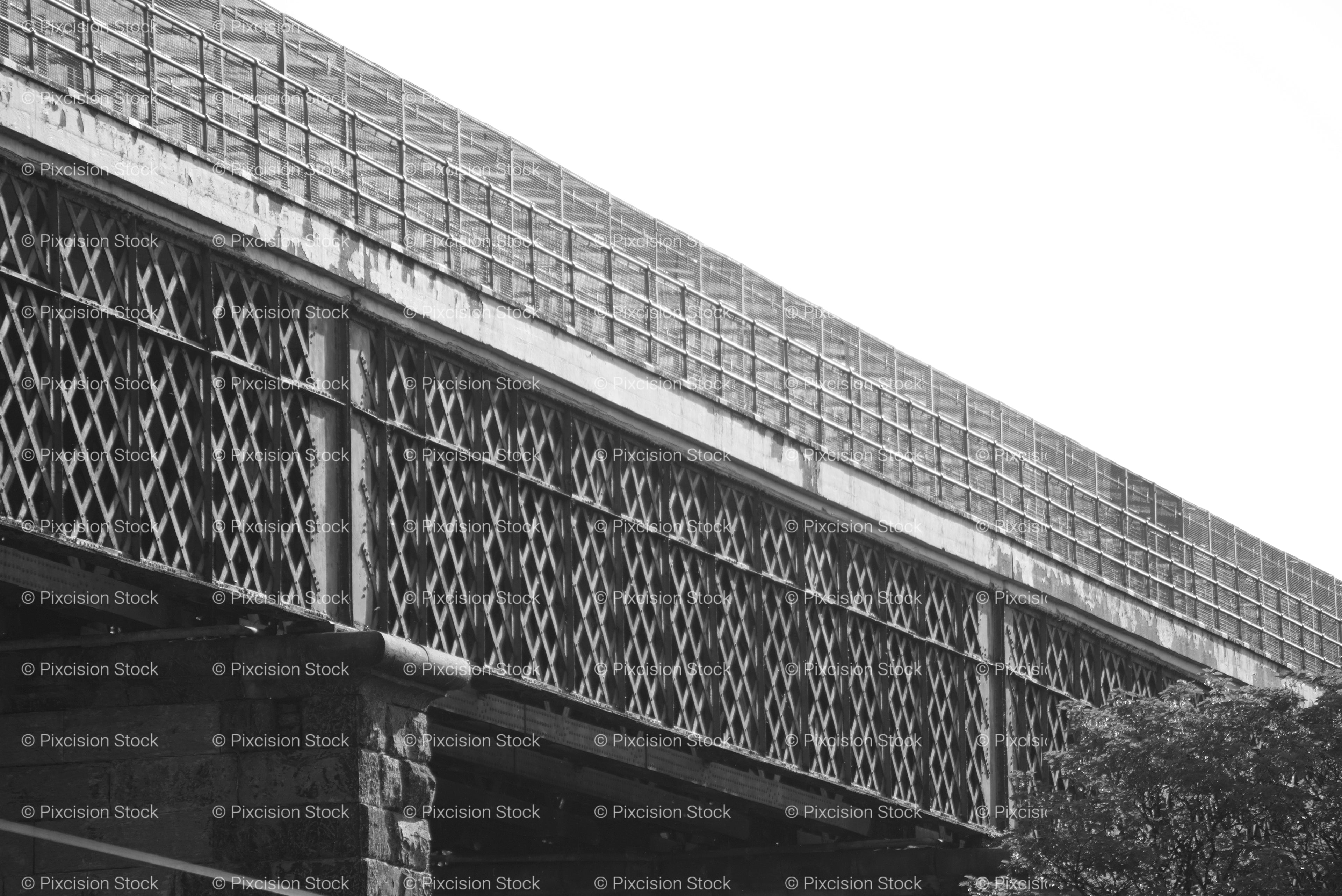 Low-Angle Exterior View of a Long Steel Lattice Footbridge (Monochrome)