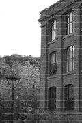 Exterior View of a Multi-Story Brick Industrial Mill Building (Monochrome)