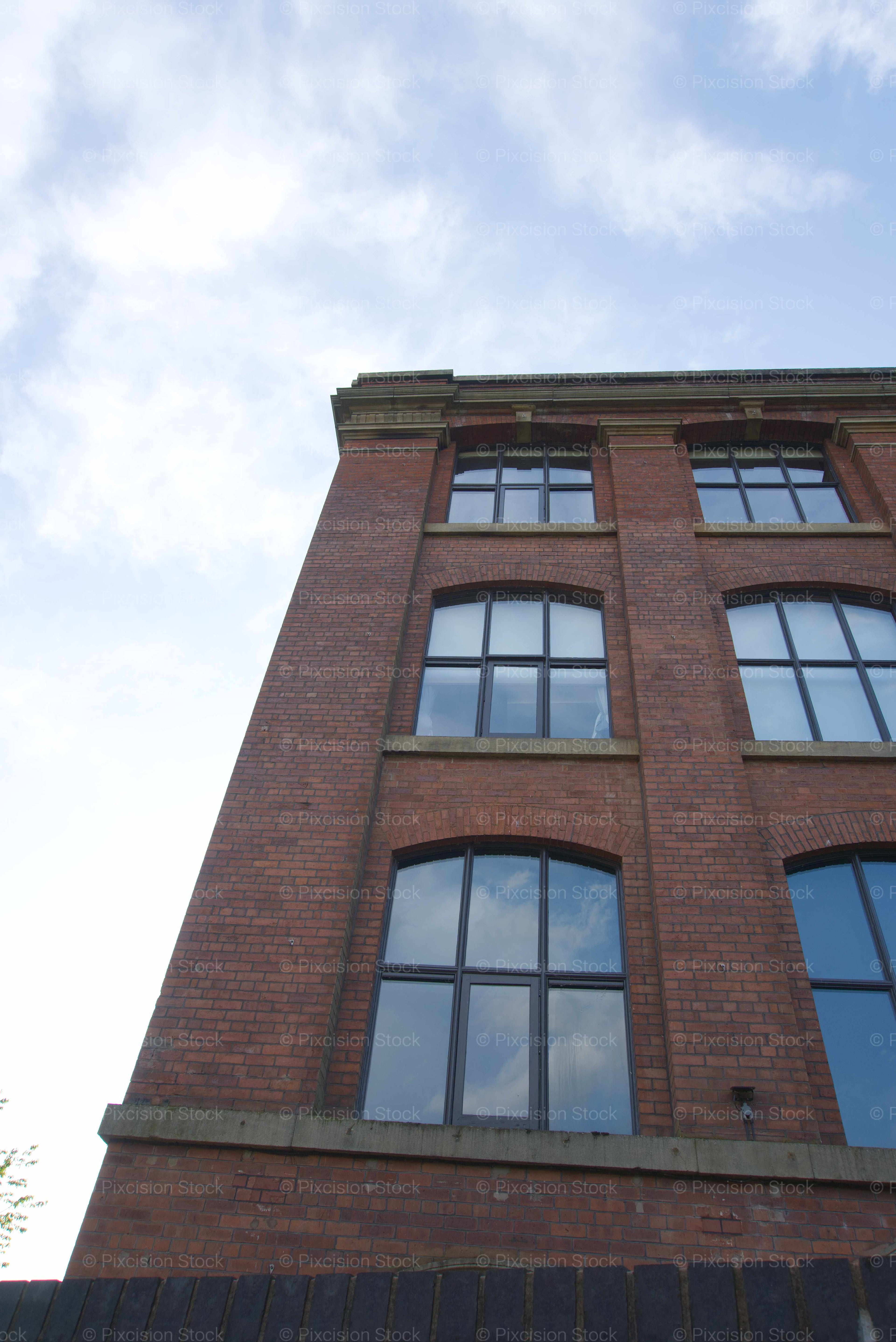 Low-Angle Shot Looking Up at the Facade of a Historic Brick Factory