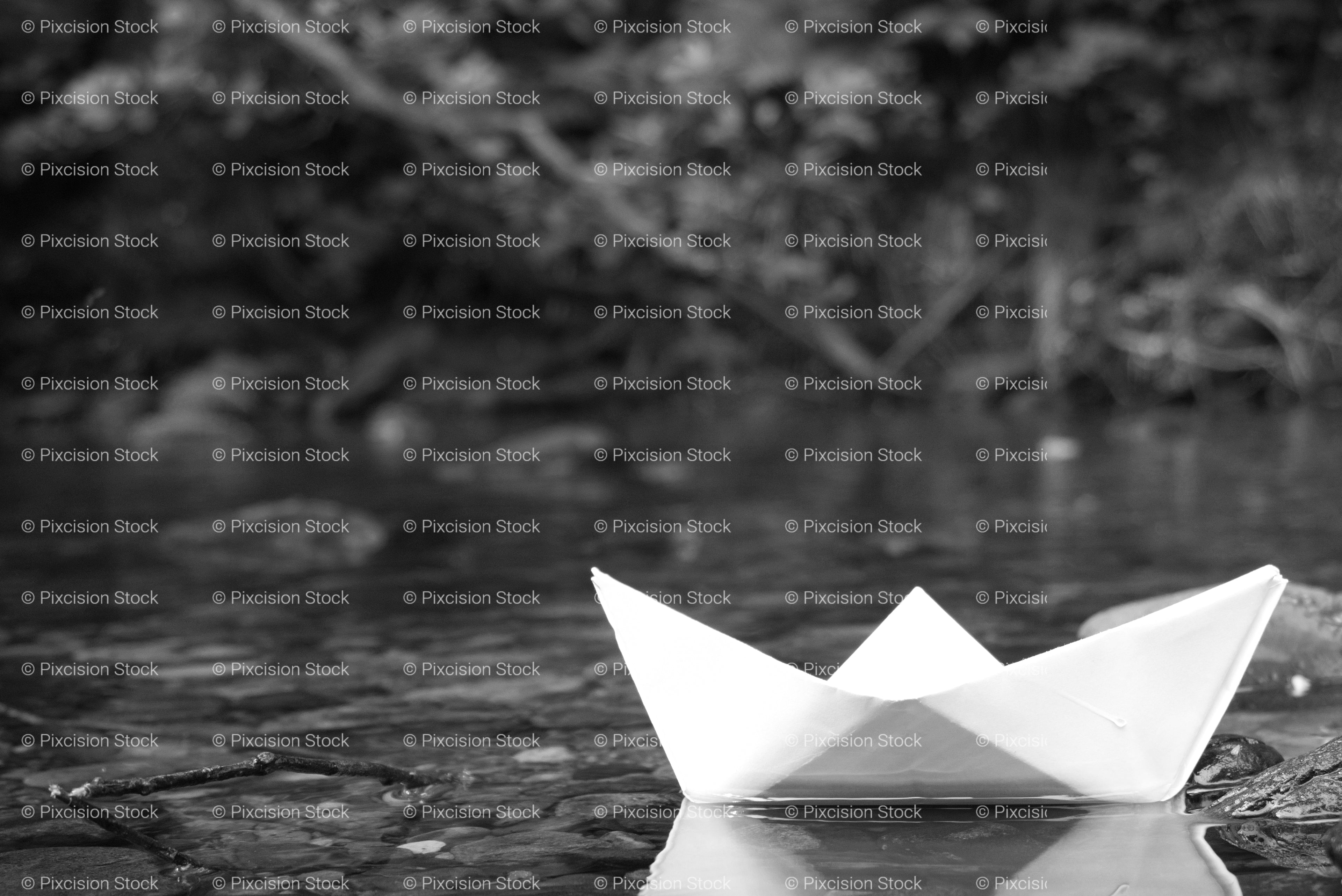 White Paper Boat Floating on a Calm Water Surface (Monochrome)