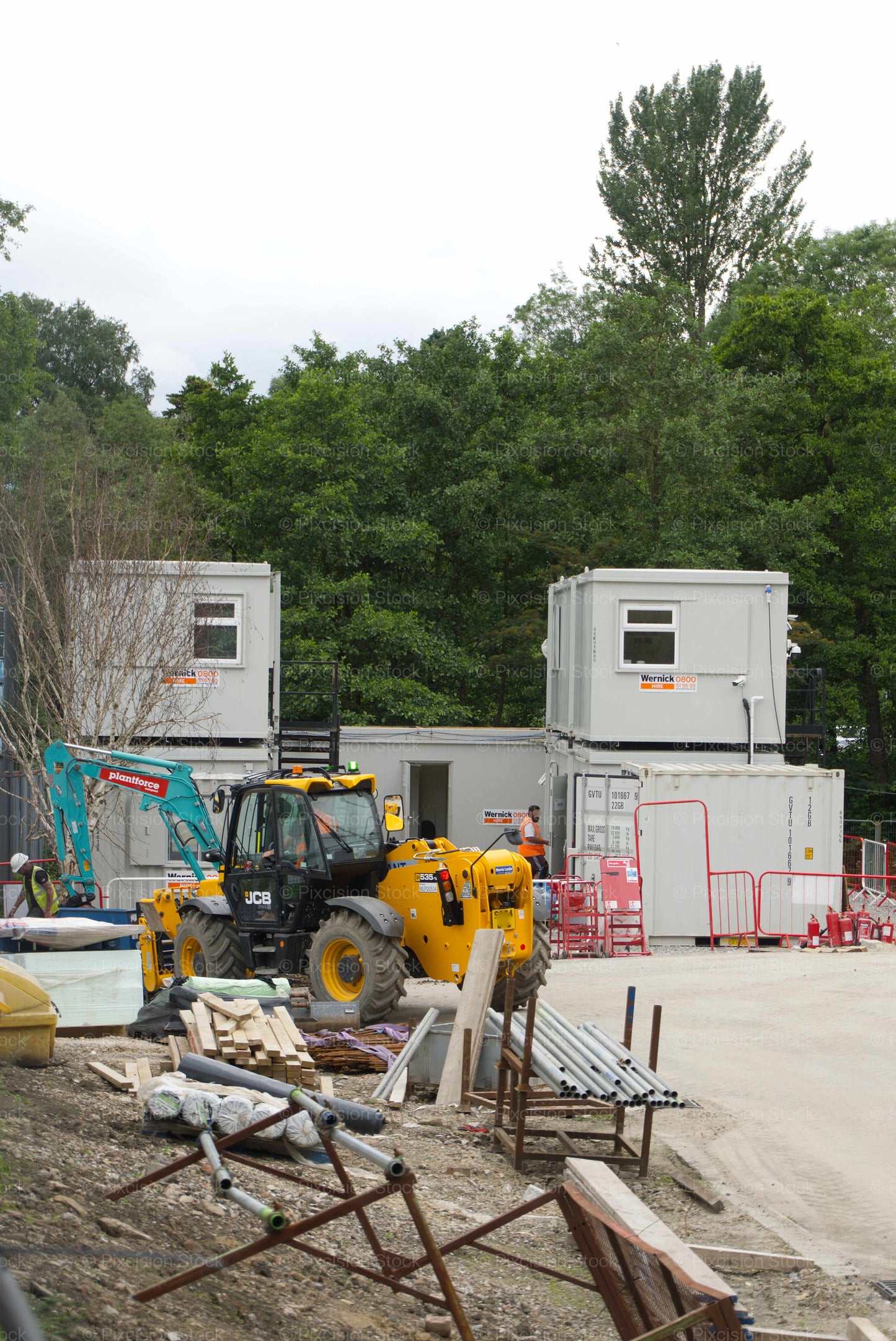 Construction site with mobile office trailers and construction equipment.