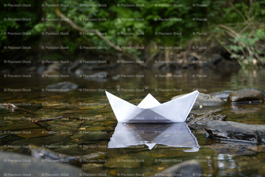 White Paper Boat Floating on a Calm Water Surface