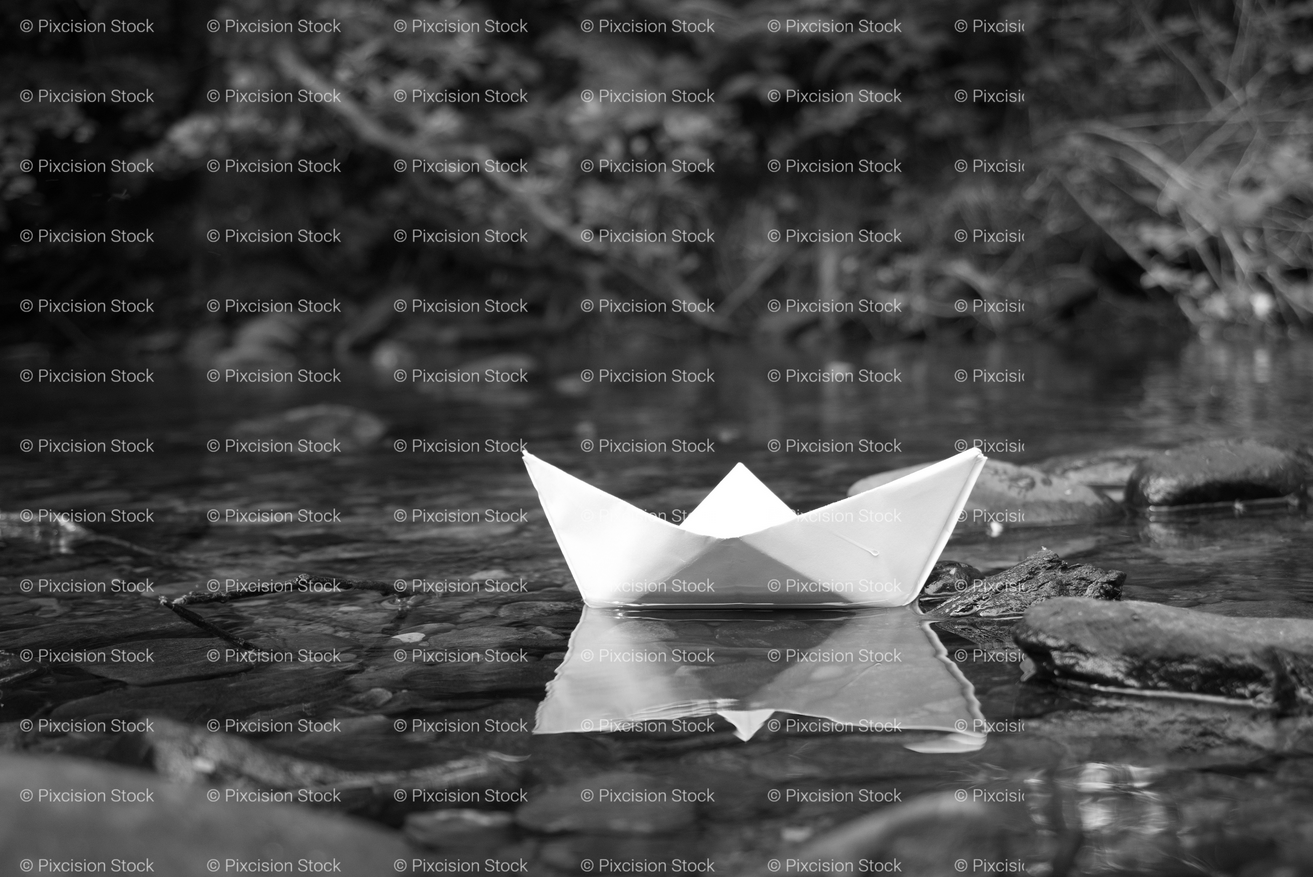 White Paper Boat Floating on a Calm Water Surface