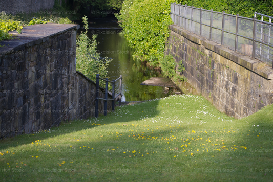 River bank with stone walls and greenery