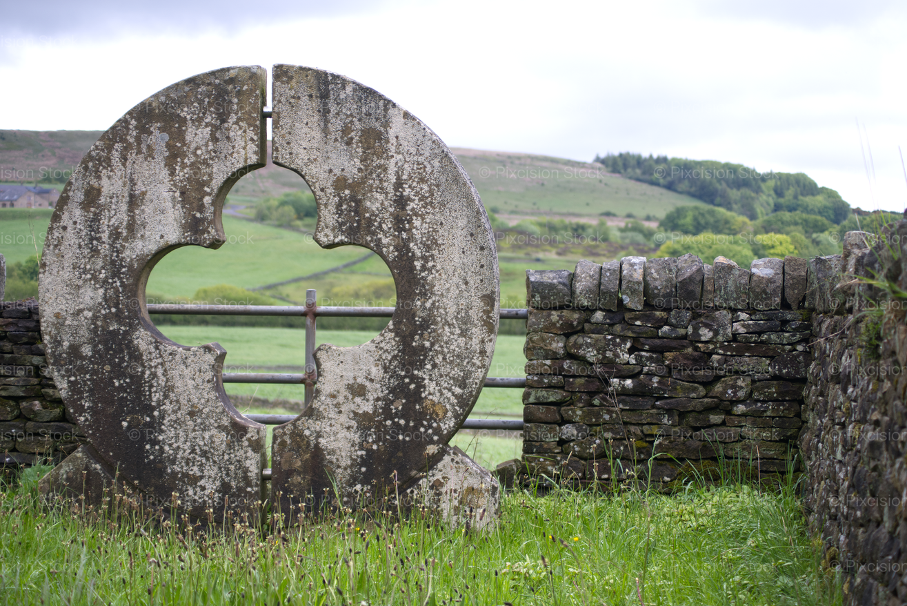 Round Monumental Stone Opening Framing a Countryside View