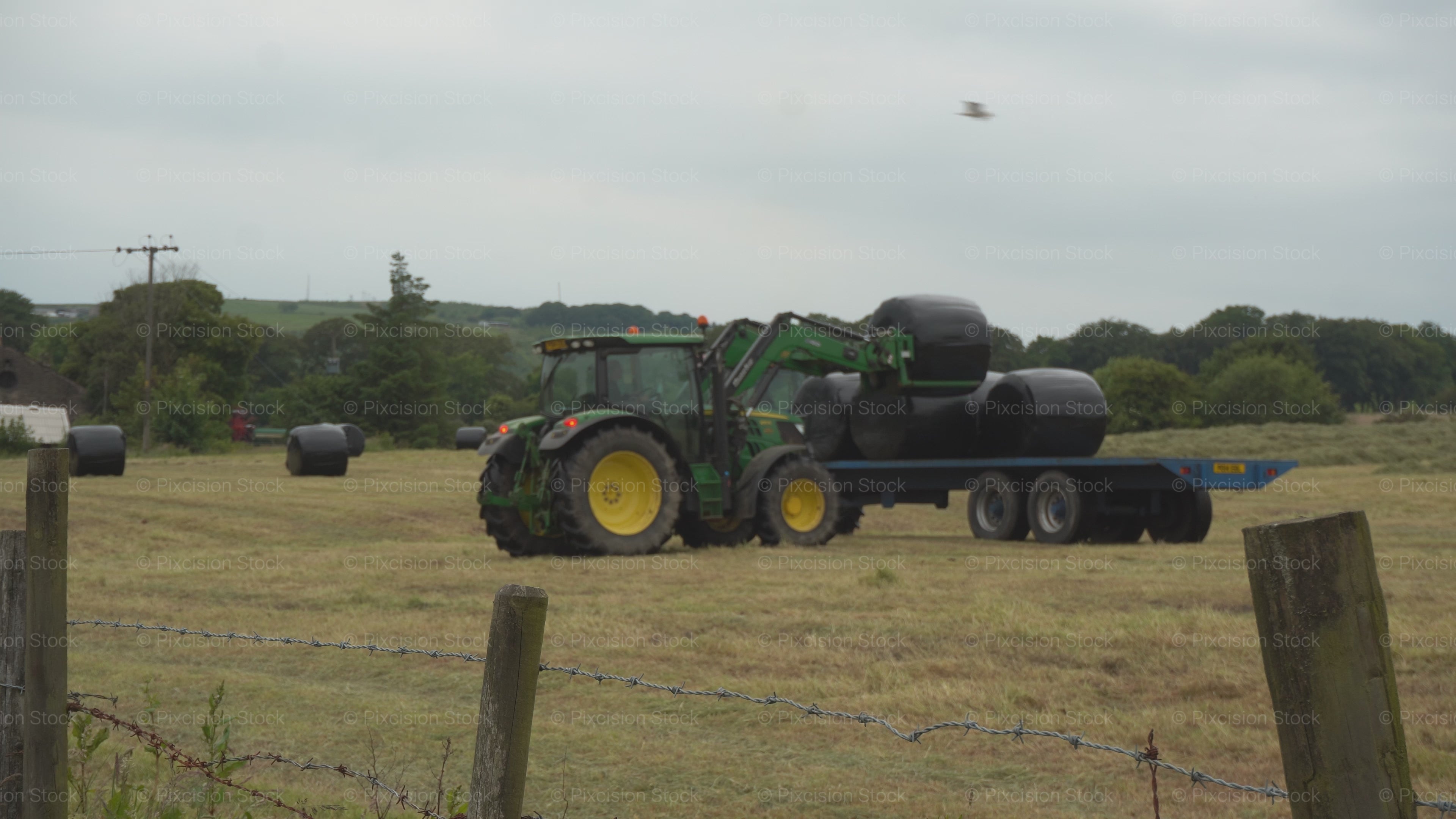 Farming Harvest Season: Green Tractor Loading Farm Bales (4K UHD 2160p)